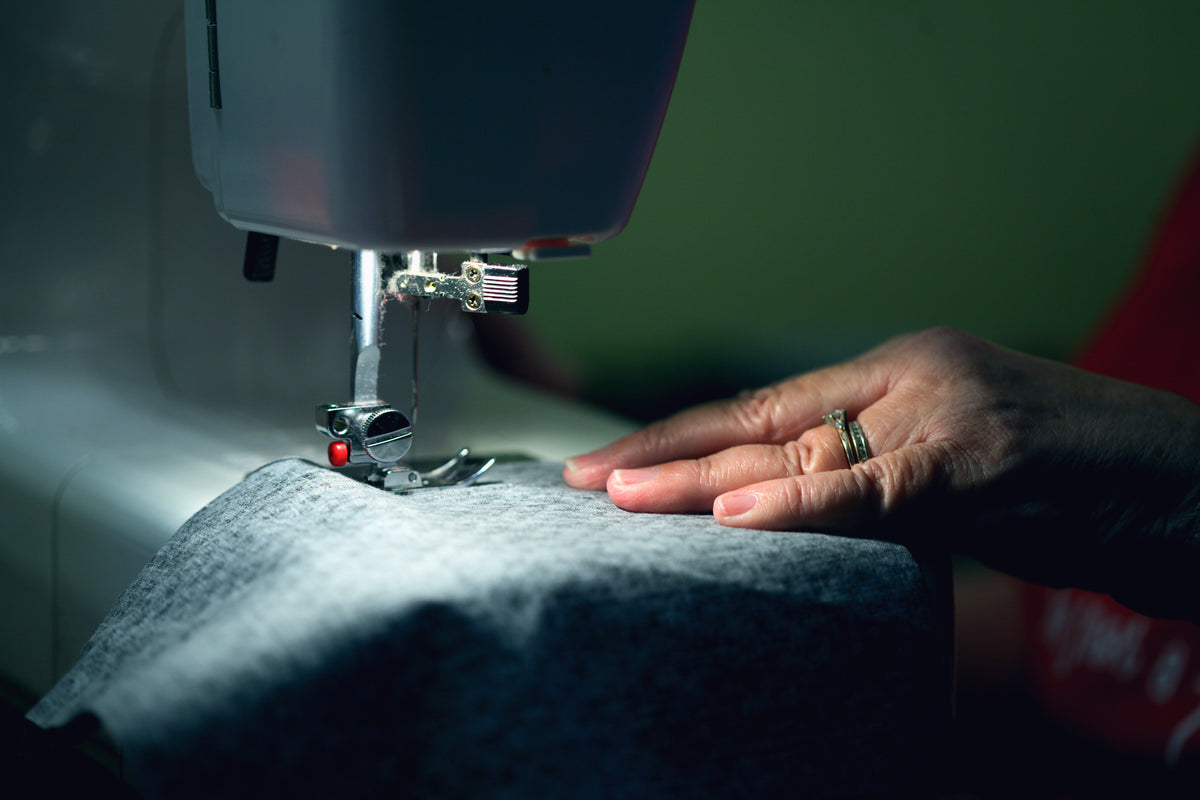 Hand holding fabric for sewing machine
