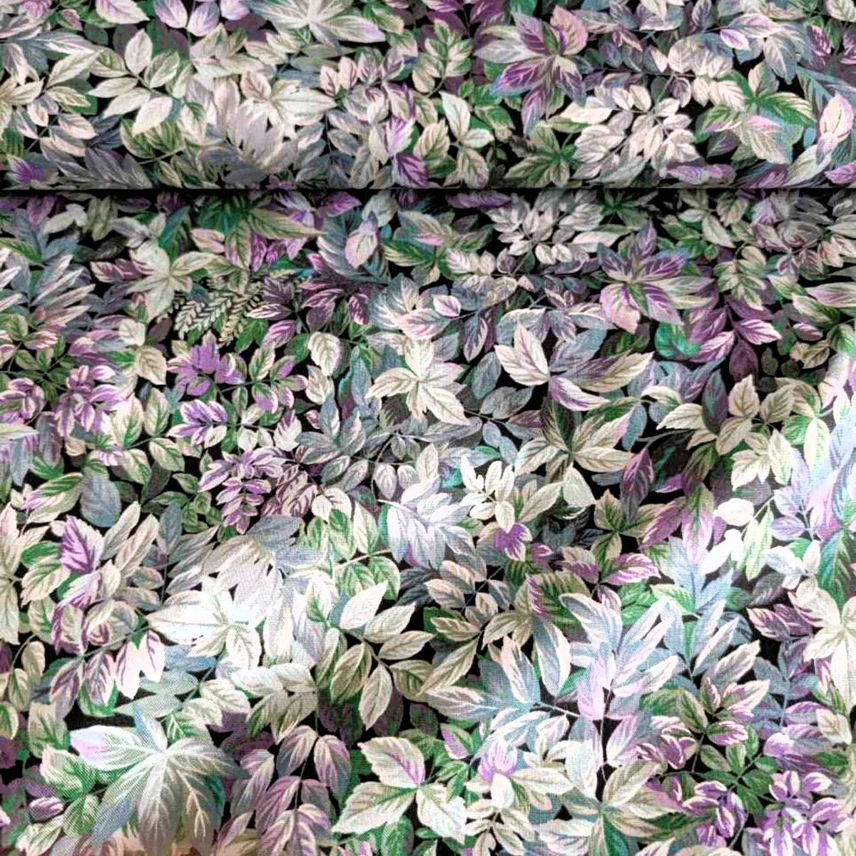 Heather in the Moonlight cotton fabric by Robert Kaufman with layered botanical leaf print in purple, green, blue, and metallic accents