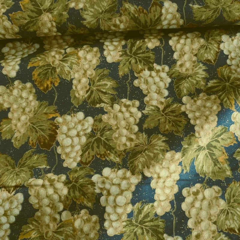 Nature’s Harvest cotton fabric by Robert Kaufman featuring green grape clusters and vine leaves on green with gold accents