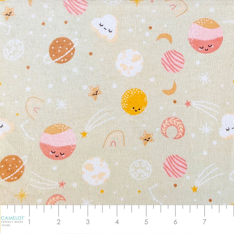 Camelot Fabrics Space Friends pink cotton flannel fabric featuring smiling planets, stars, moons, clouds, and rainbows from the Fleece and Flannel 2026 Collection.