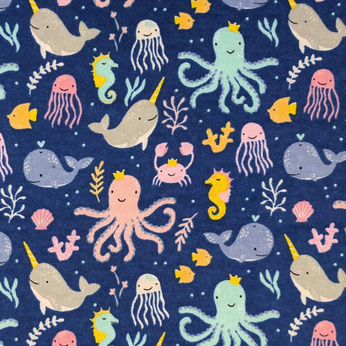 Ocean Baby navy cotton flannel fabric featuring whales, narwhals, octopuses, jellyfish, seahorses and sea life.
