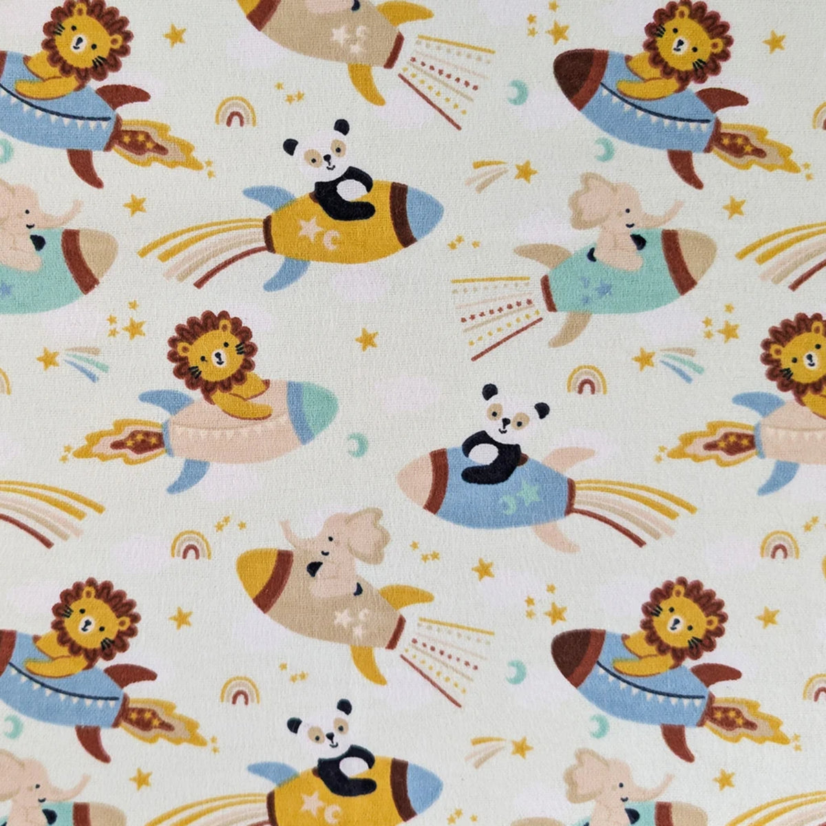 Universe Baby light aqua cotton flannel fabric with lions, pandas and elephants riding rockets among stars and moons.