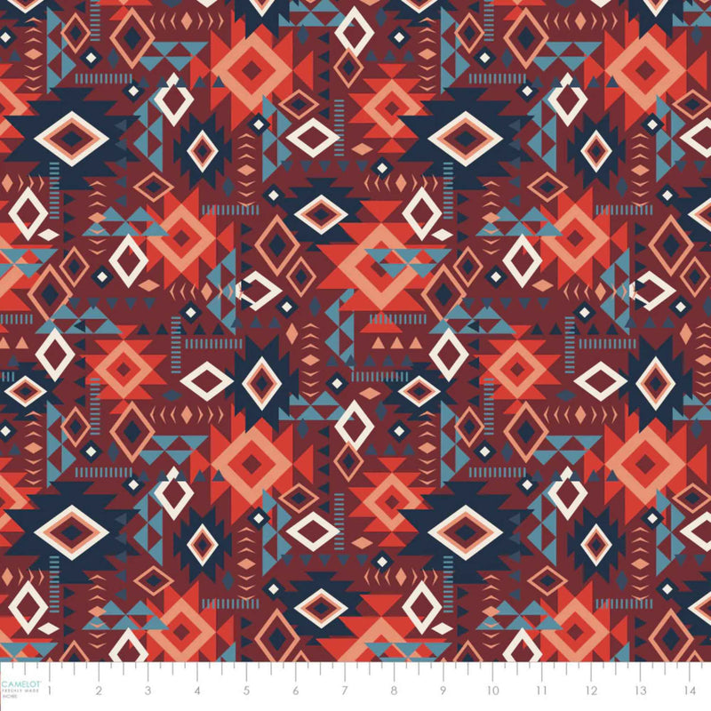 “Rust red Southwestern geometric cotton fabric with layered Aztec diamond motifs.”