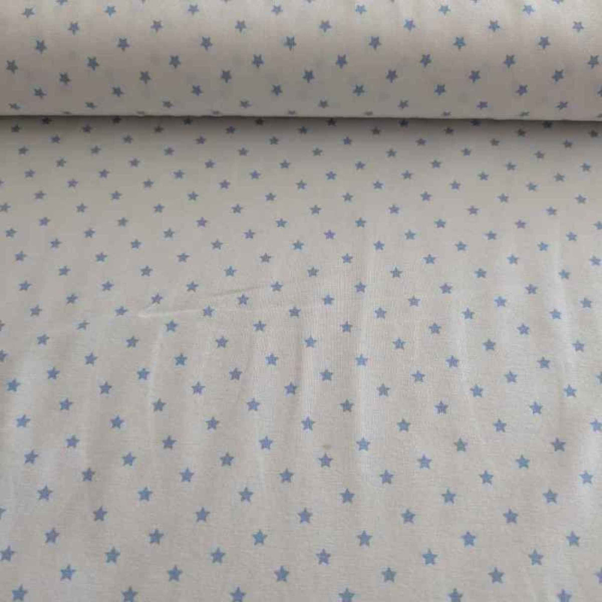 Organic cotton jersey knit fabric with blue star pattern on white background
