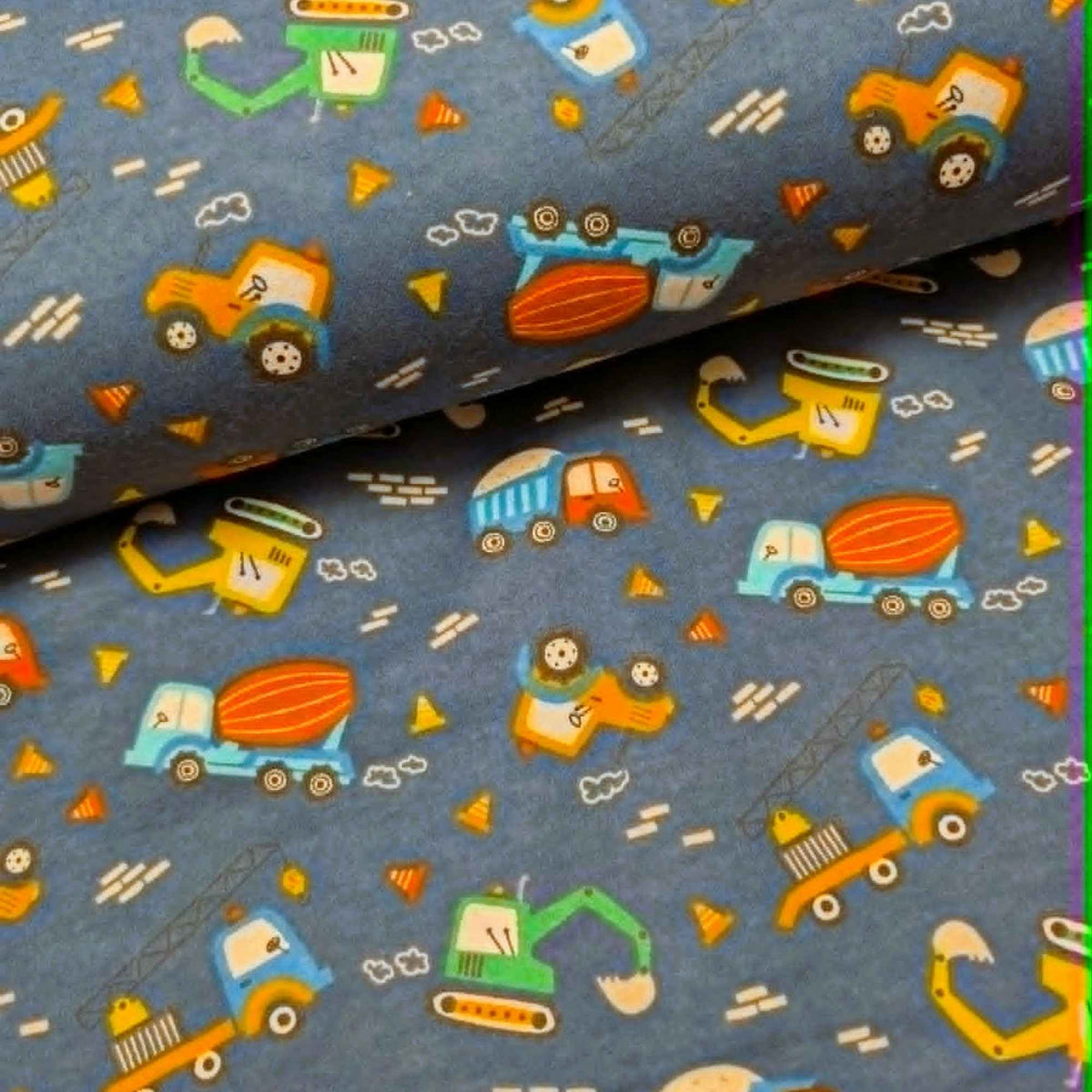 Navy cotton flannel fabric with colorful construction vehicles including excavators, cranes, dump trucks and cement mixers.