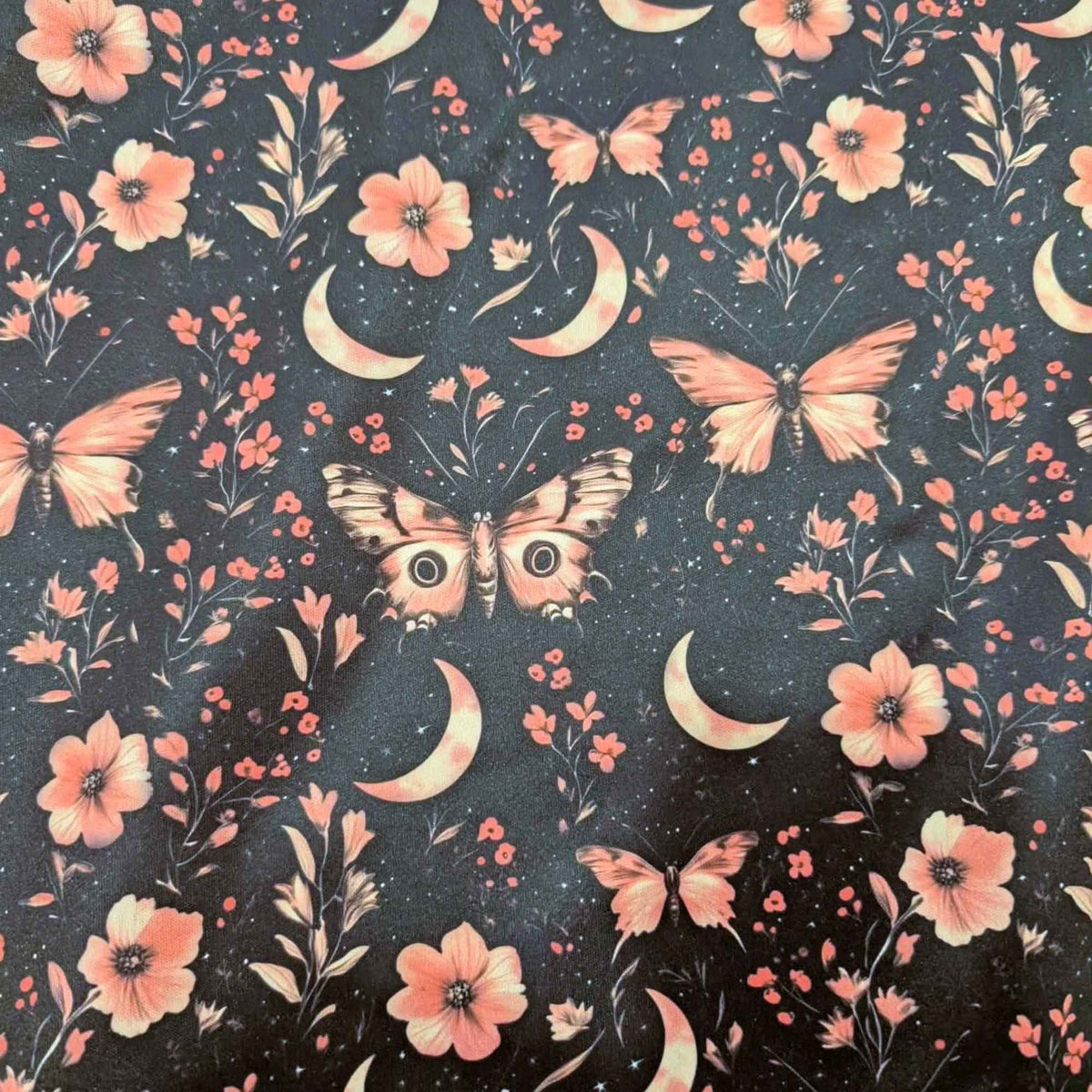 Moonlit Blush Moths exclusive waterproof PUL fabric with pink moths, crescent moons, flowers and stars on a black background