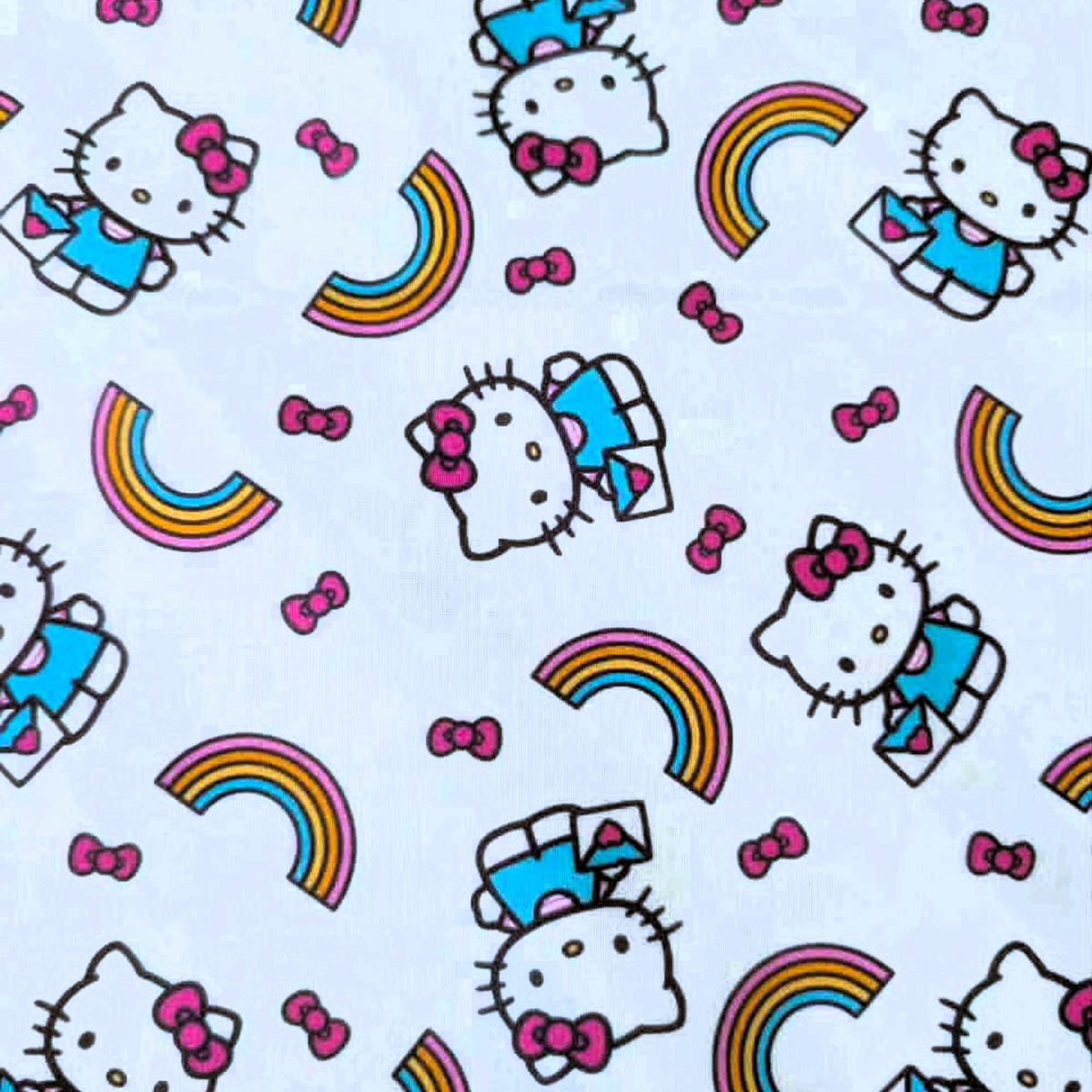 Officially licensed Hello Kitty rainbow cotton fabric by Springs Creative featuring Hello Kitty, colorful rainbows and pink bows on a white background.