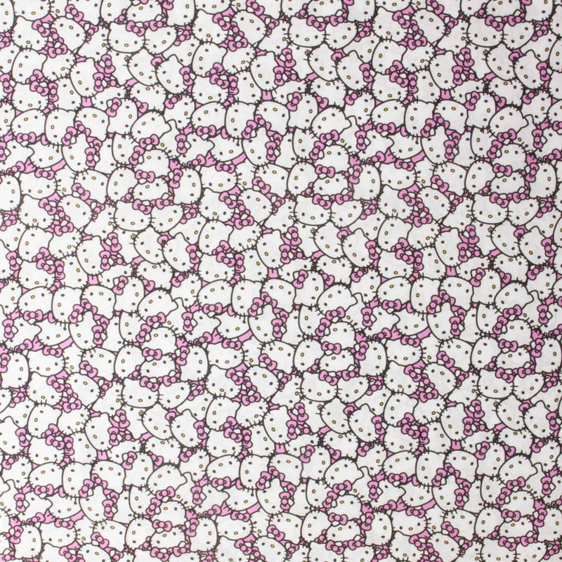 Officially licensed Hello Kitty cotton fabric by Springs Creative featuring an all-over packed print of Hello Kitty faces with pink bows on a soft pink background.