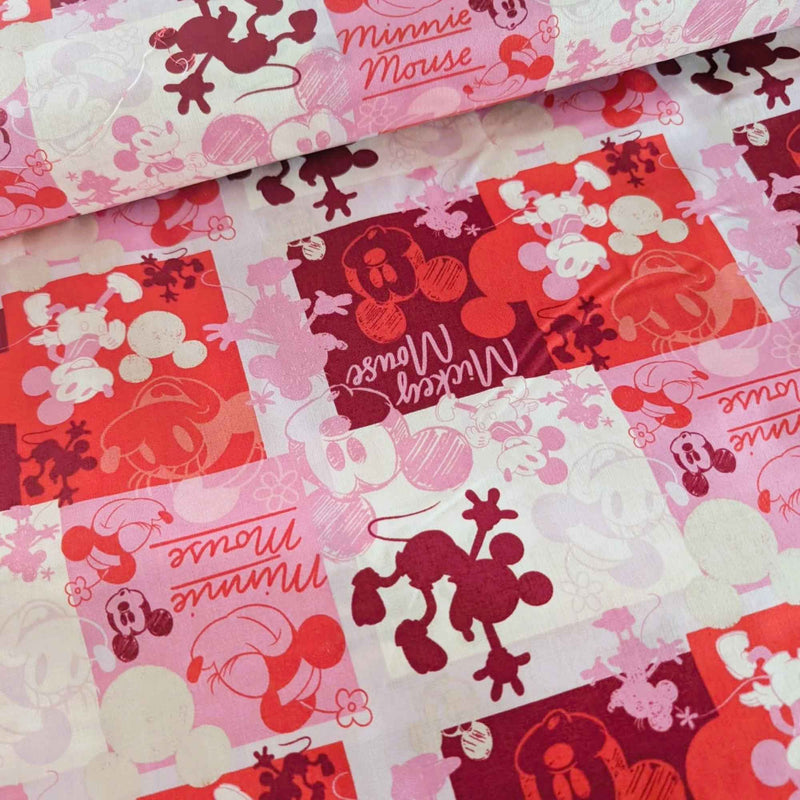 Mickey and Minnie Mouse collage cotton fabric in pink red and cream by Springs Creative CP80470