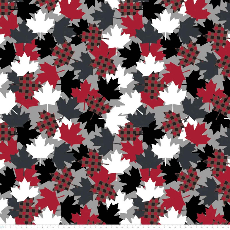 Maple Leaves fleece by Camelot with overlapping red, black, grey and white leaves, including red and black plaid maple leaves with ruler for scale.