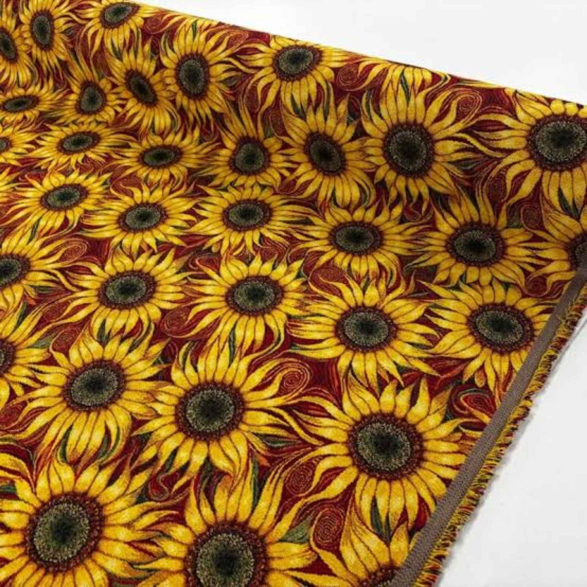 Sunflower Gobelin tapestry fabric with golden yellow petals, green accents and swirling details on a deep red background.