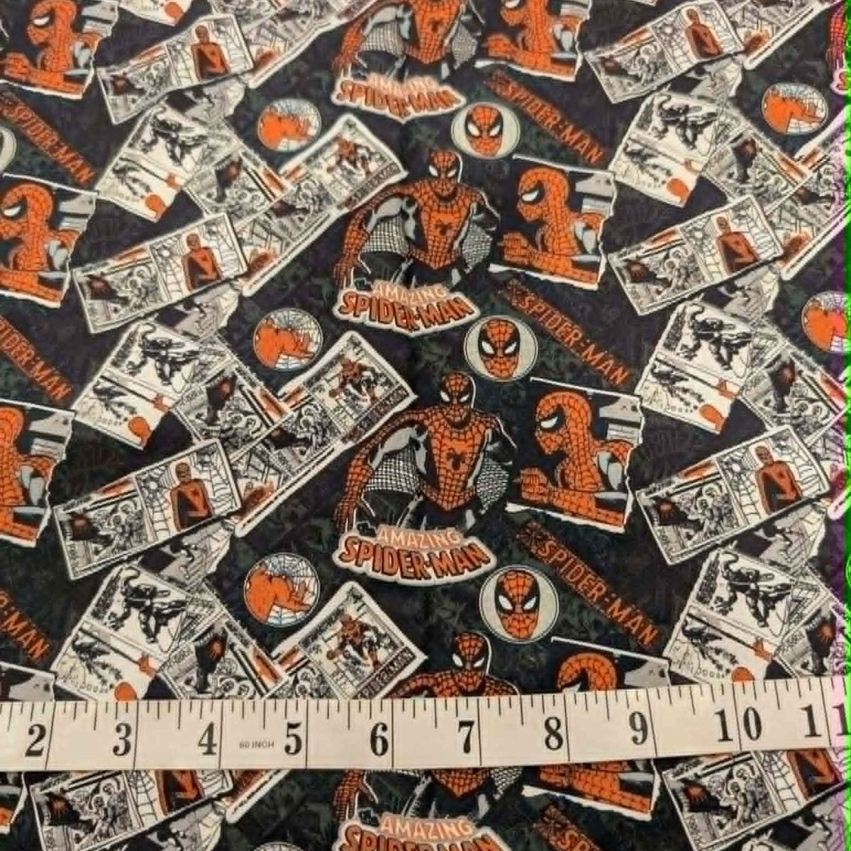 Marvel Amazing Spider-Man comic collage quilting cotton fabric featuring vintage comic panels, Spider-Man logos, character artwork, and mask icons on a black background.