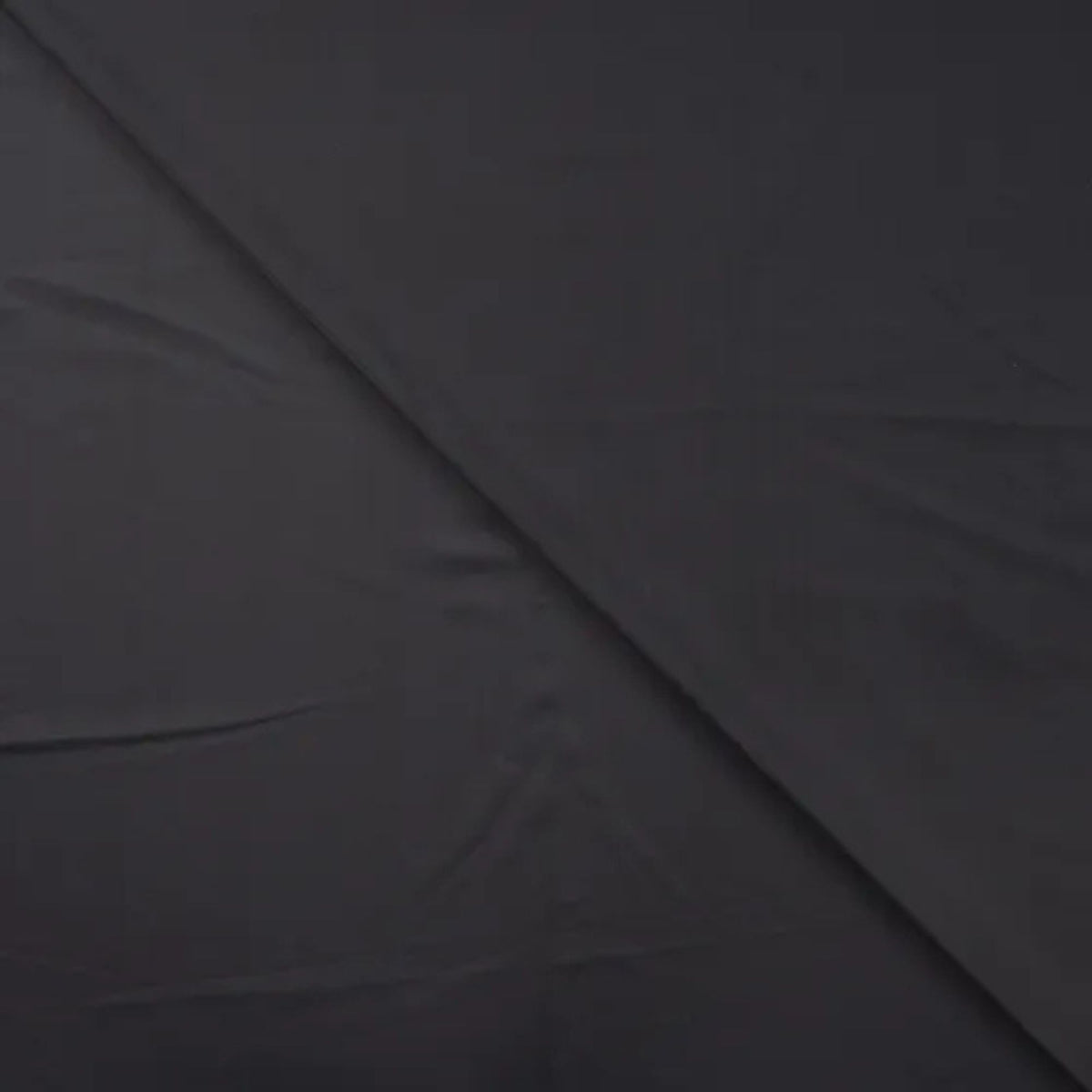 Solid black stretch jersey fabric for sportswear and swimwear – smooth, breathable, and perfect for activewear projects