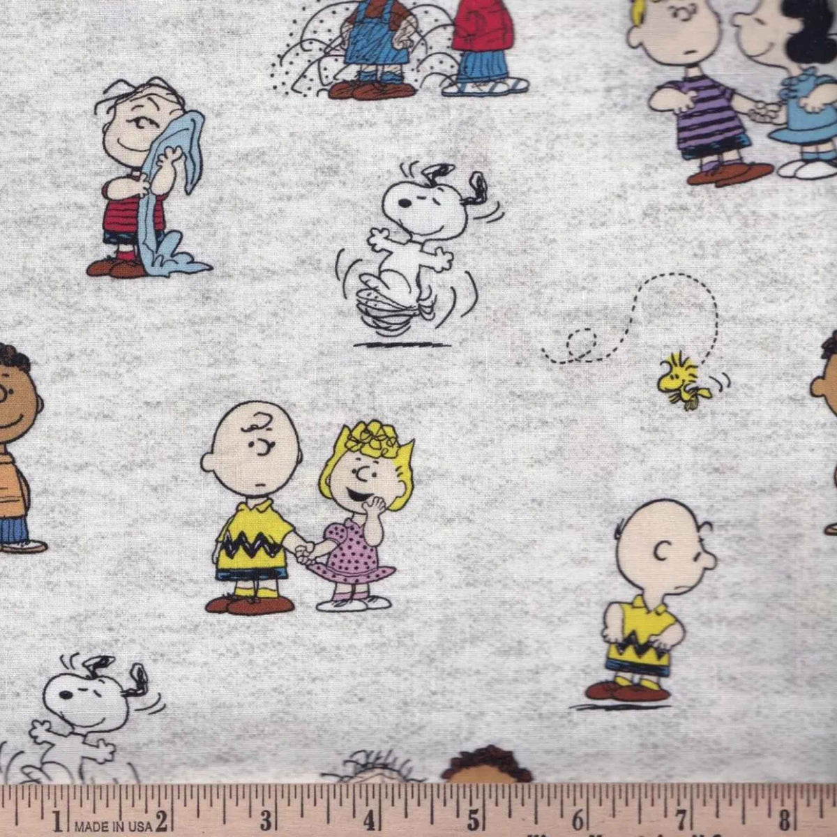 Peanuts gang character toss cotton fabric on light grey by Springs Creative CP78731