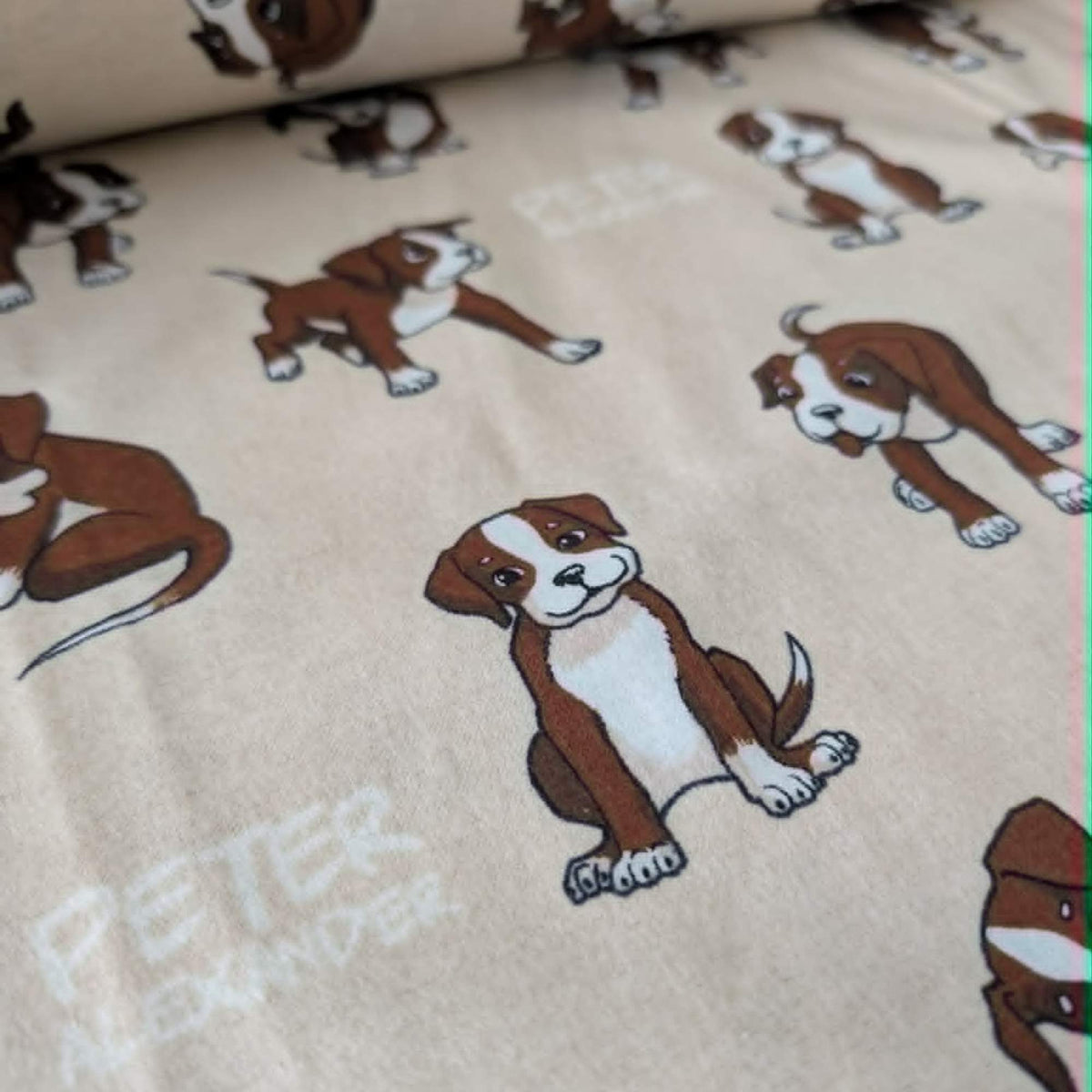 Double brushed flannel fabric featuring playful brown and white puppies in various poses on a cream background.
