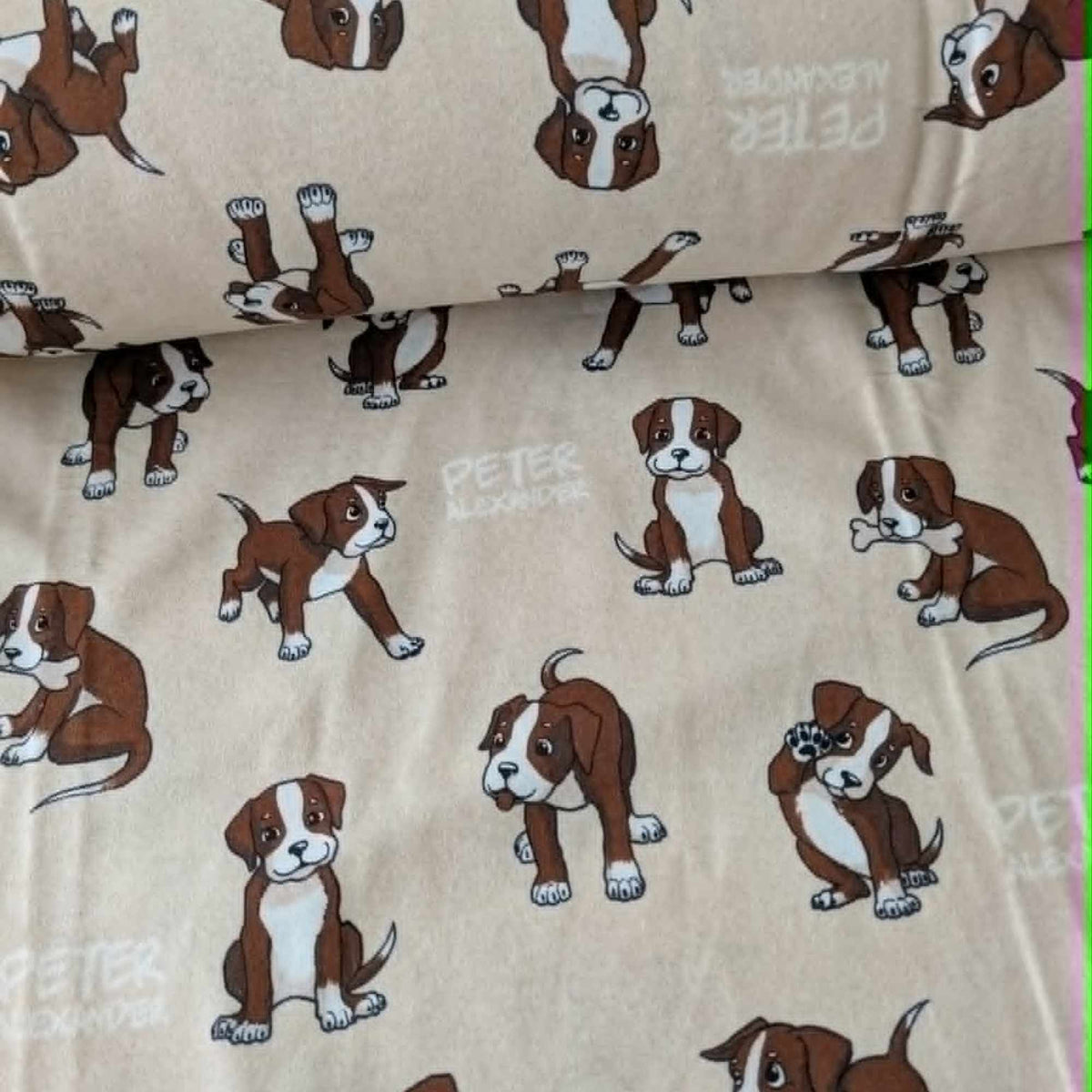 Double brushed flannel fabric featuring playful brown and white puppies in various poses on a cream background.