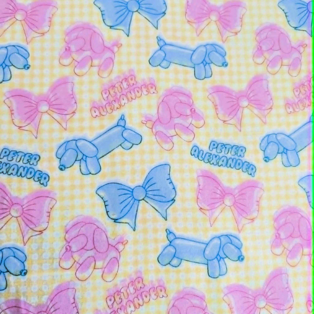 Double brushed flannel fabric featuring pastel balloon dogs, decorative bows, and a yellow gingham background in pink and blue tones.