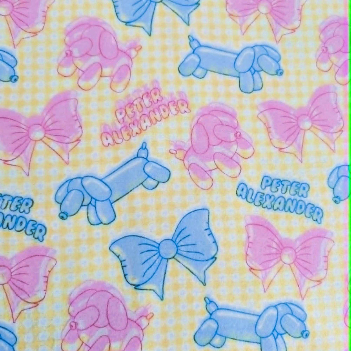 Double brushed flannel fabric featuring pastel balloon dogs, decorative bows, and a yellow gingham background in pink and blue tones.