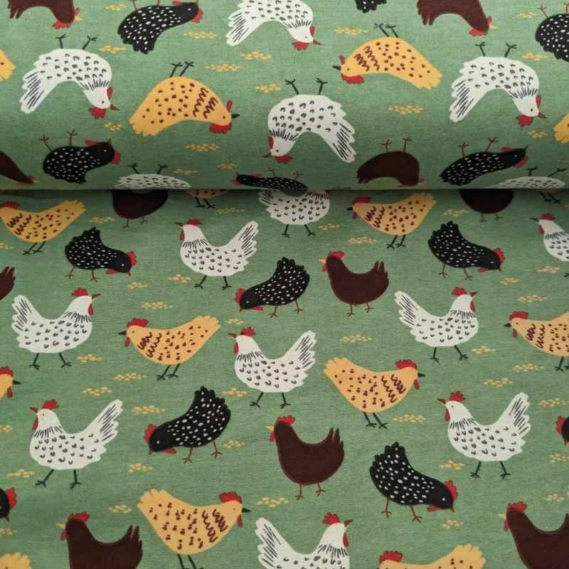 Cotton flannel fabric with beige, black, and white chickens scattered on a soft green background – ideal for quilts, blankets, and farmhouse-themed projects.