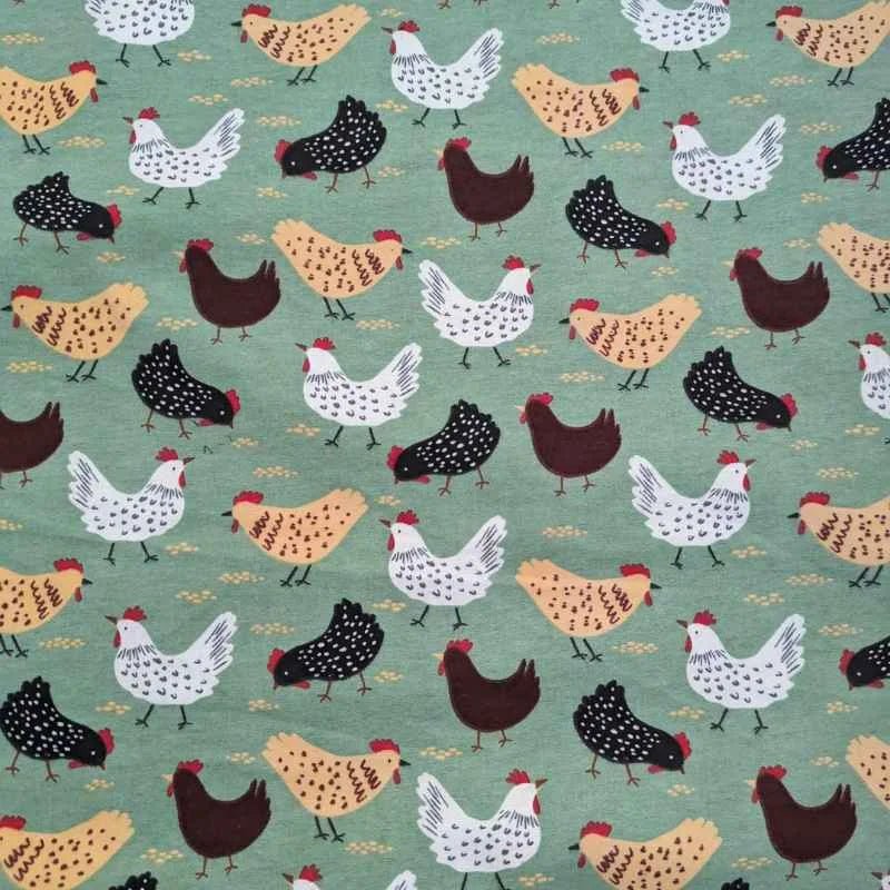Cotton flannel fabric with beige, black, and white chickens scattered on a soft green background – ideal for quilts, blankets, and farmhouse-themed projects.