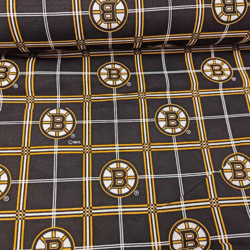Boston Bruins plaid flannel cotton fabric with black, gold, and white tartan design and repeating NHL Bruins logos.
