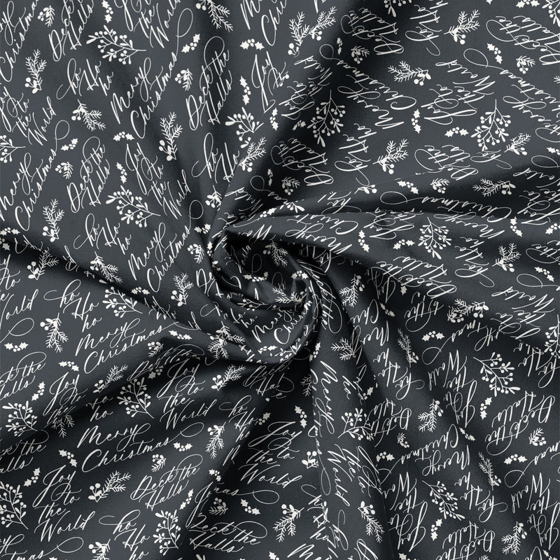 Detail view of Joy to the World Christmas Script on Charcoal quilting cotton showing print scale and drape.