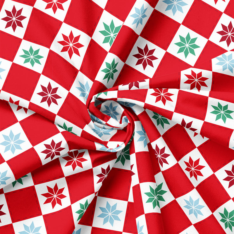 Close-up of patchwork snowflake block print showing fabric drape and scale