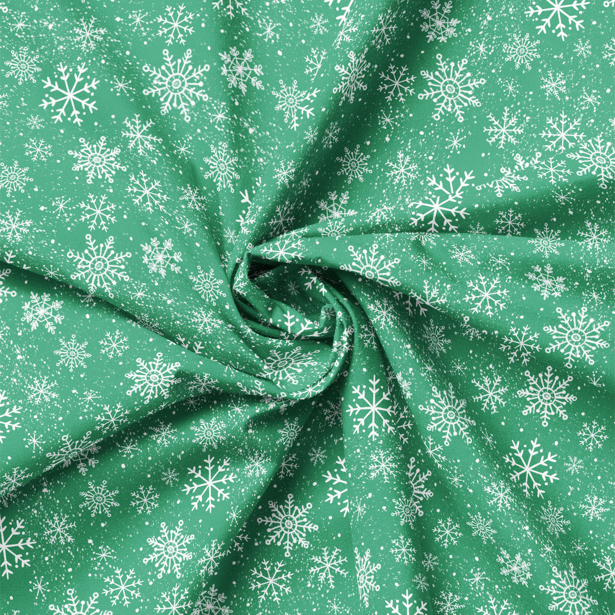 Close-up of green snowflake fabric showing folds and print scale