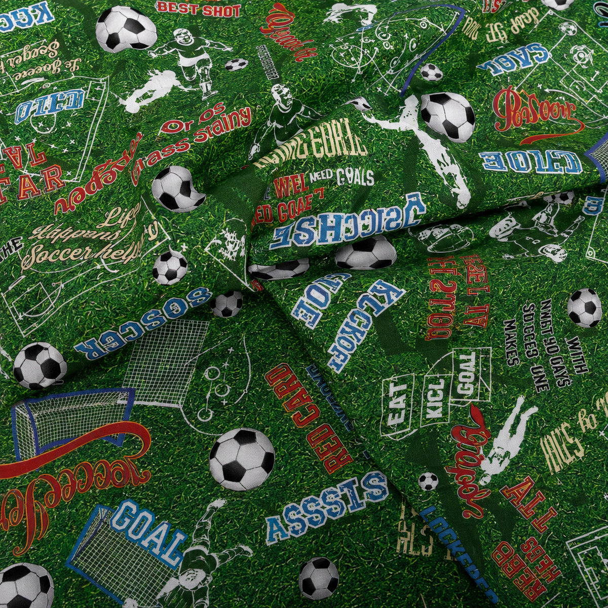 Green soccer cotton fabric featuring soccer balls, goal nets, field diagrams and motivational sports phrases.