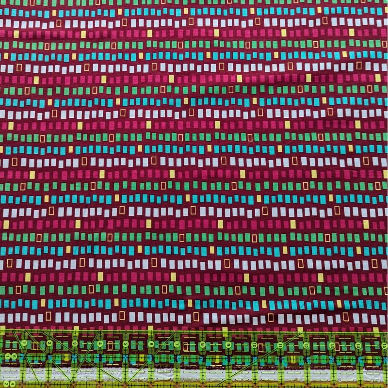 Small Rectangles of Various Colours on Burgundy - Dinosaur Blocks