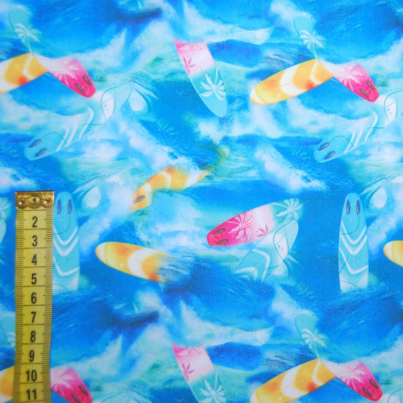 Blue swim fabric with colorful surfboards and wave pattern – Oeko-Tex certified stretch knit for swimwear, board shorts, and beachwear projects